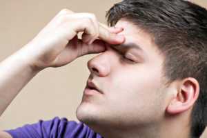 stressed young man because of lots of bills trying to decide whether to file for bankruptcy